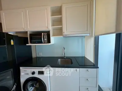 Modern kitchen with sleek appliances and ample storage space