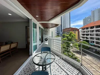 Spacious balcony with stylish seating and city view, perfect for relaxation and entertainment.