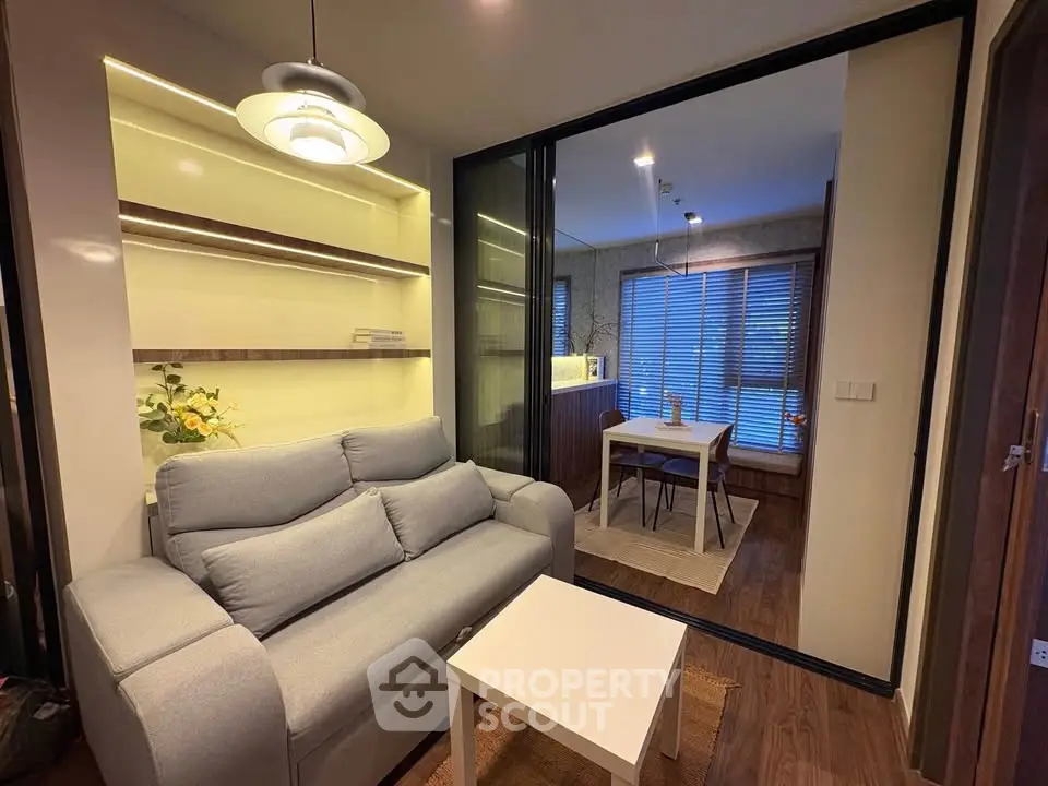 Modern living room with cozy sofa and dining area in open layout apartment
