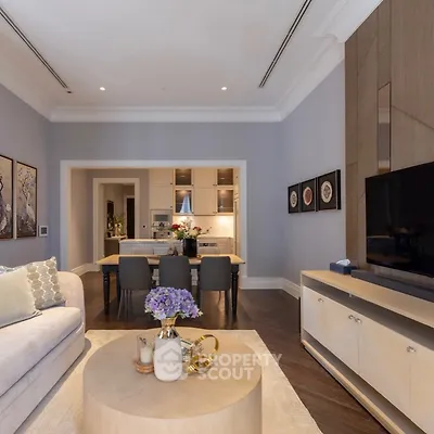 Luxurious open-plan living room with elegant decor and modern kitchen
