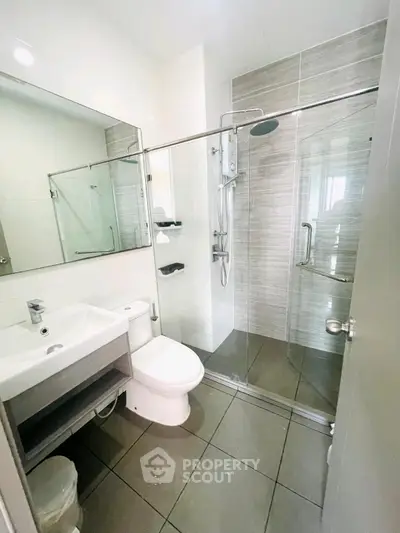 Modern bathroom with glass shower enclosure and sleek fixtures