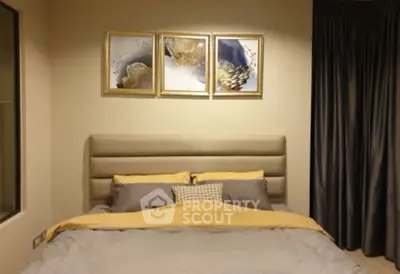 Cozy bedroom with elegant decor and modern artwork above the bed, perfect for relaxation.