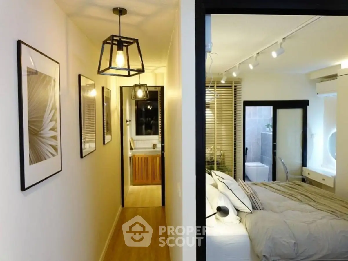 Modern bedroom with ensuite bathroom and stylish hallway lighting