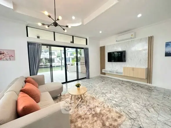 Spacious modern living room with large windows and stylish decor