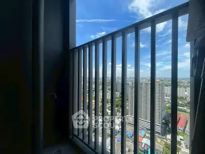 Stunning high-rise balcony view showcasing city skyline and blue sky.