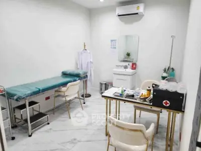 Modern medical office with examination table and equipment in a bright, clean setting.