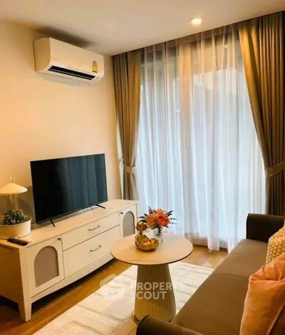 Charming living room with modern decor, featuring a cozy sofa, elegant curtains, and a sleek TV setup.