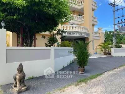 Charming exterior view of The Bay View Condo with lush greenery and elegant architecture.