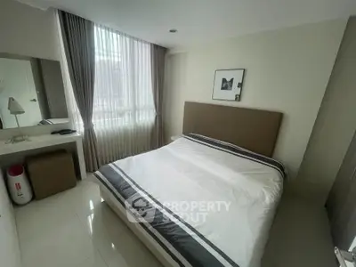 Modern bedroom with stylish decor and ample natural light