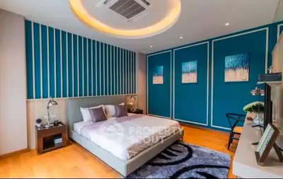 Modern bedroom with stylish decor and cozy ambiance, featuring a comfortable bed and elegant wall art.