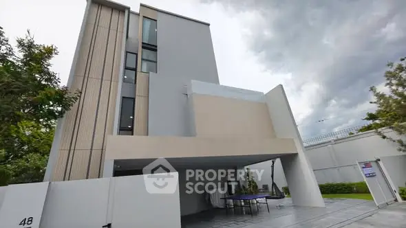Modern multi-story building with sleek design and spacious outdoor area.