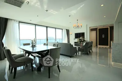 Luxurious open-plan living and dining area with elegant furnishings and panoramic city views.