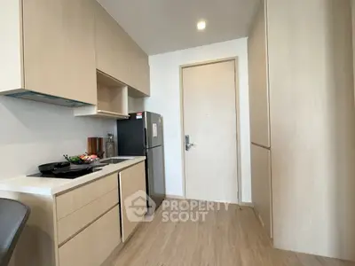 Modern kitchen with sleek cabinetry and integrated appliances in a stylish apartment.