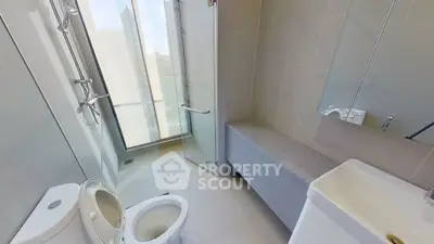 Modern bathroom with glass shower and sleek fixtures