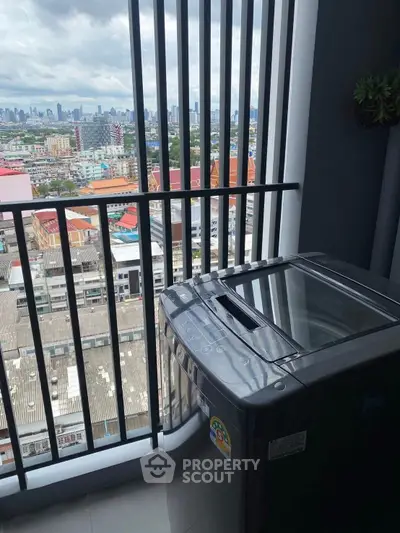 High-rise balcony with city view and washing machine, perfect for urban living.