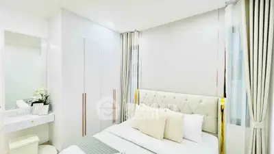 Elegant bedroom with modern decor and ample natural light