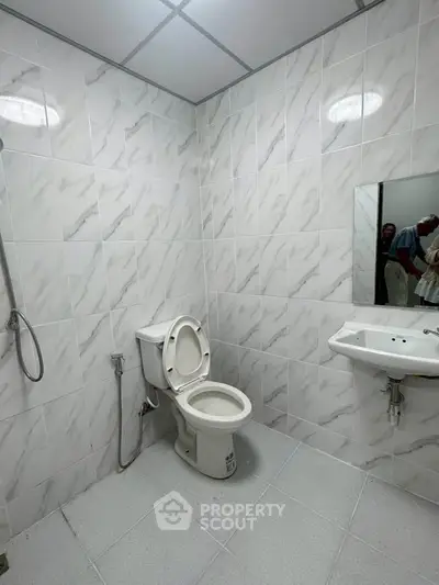 Modern bathroom with sleek white tiles and contemporary fixtures