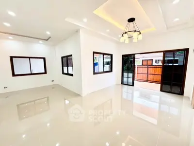 Spacious modern living room with elegant lighting and large windows for natural light.