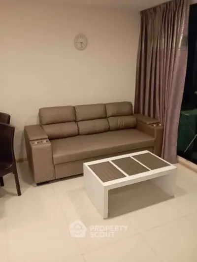 Modern living room with sleek leather sofa and stylish coffee table, perfect for cozy relaxation.