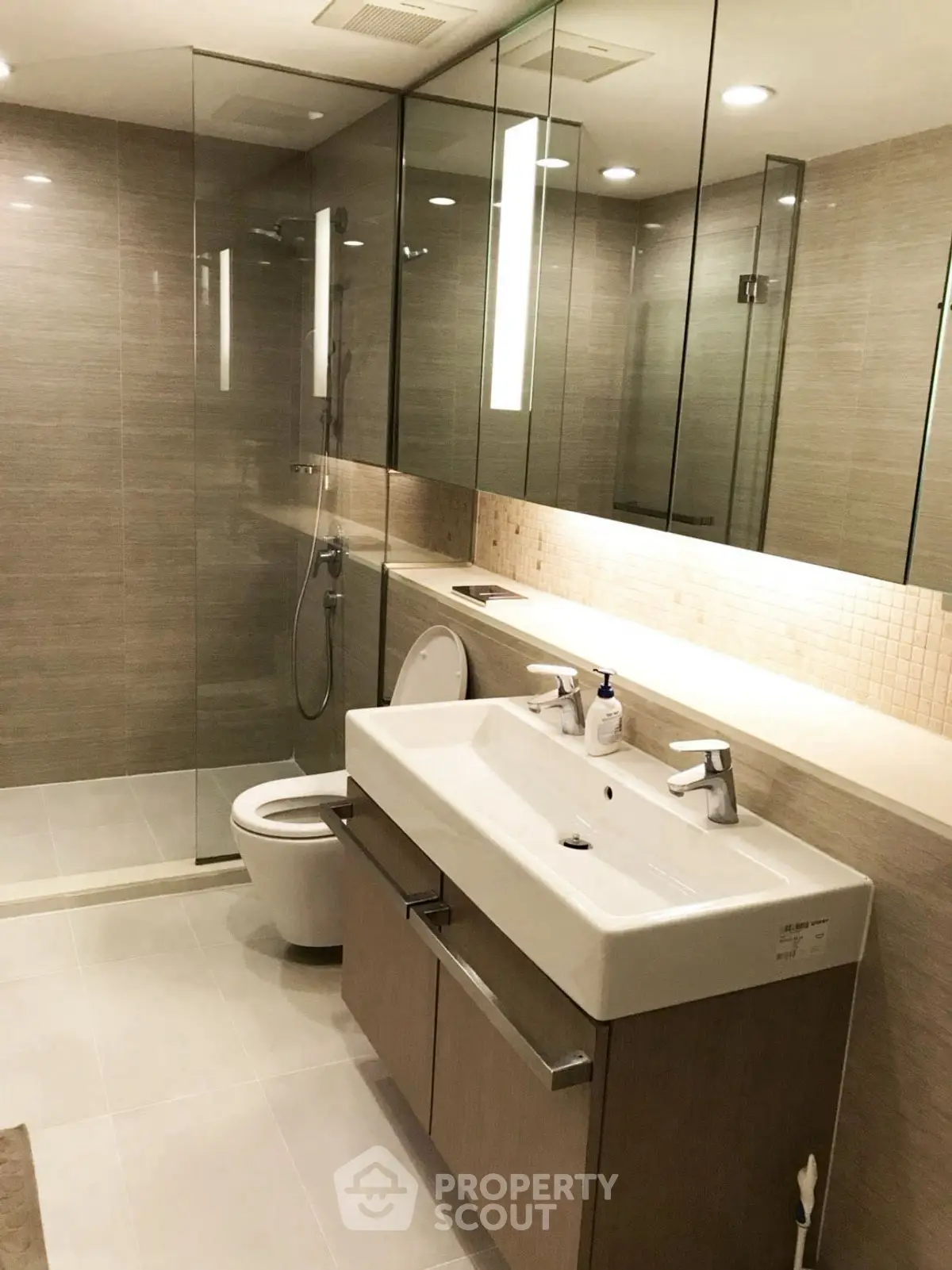 Luxurious modern bathroom with glass shower and sleek vanity