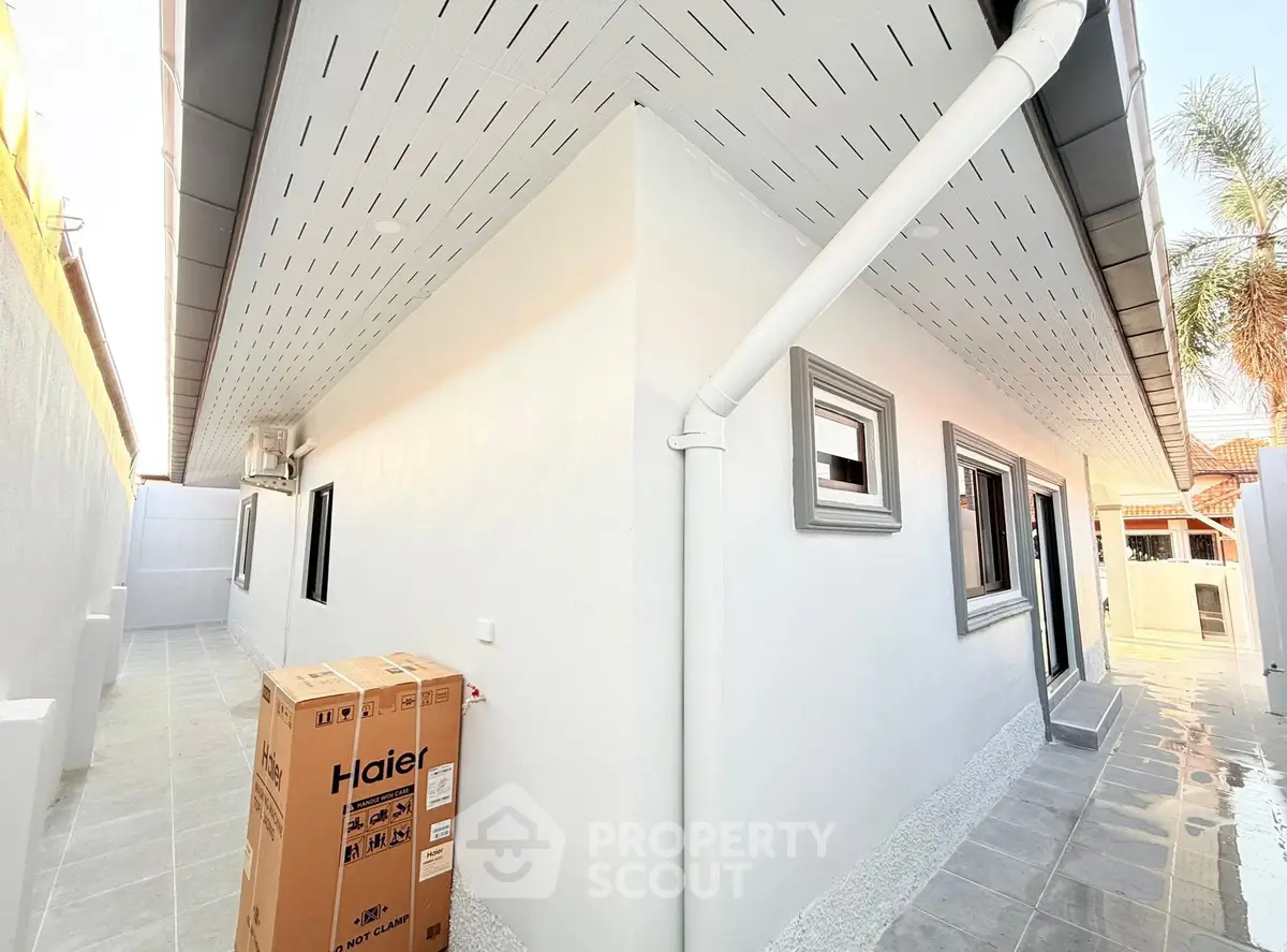 Modern exterior view of a newly constructed home with sleek design and spacious outdoor area.