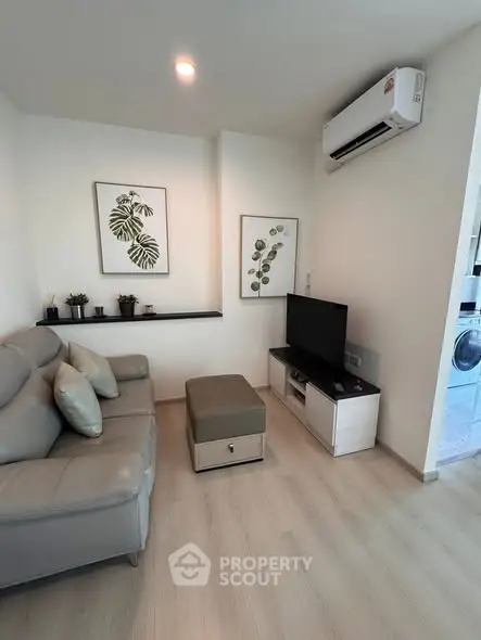 Modern living room with sleek furniture and air conditioning, perfect for cozy relaxation.