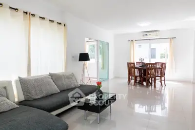Spacious modern living room with elegant dining area and natural light