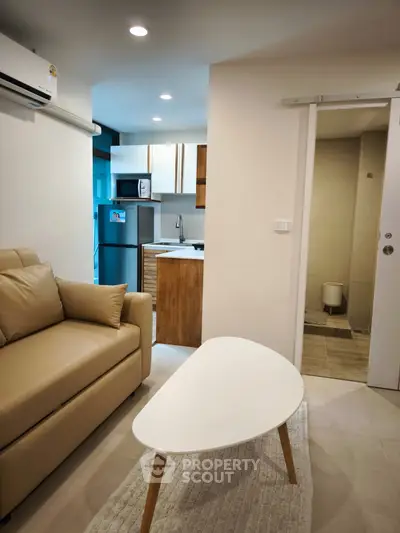 Modern apartment interior with cozy living room and compact kitchen