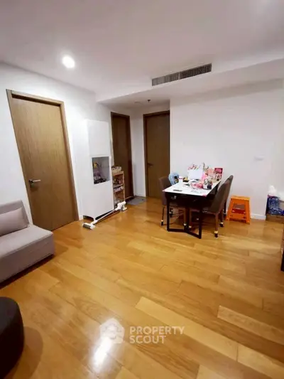 Spacious living room with wooden flooring and modern furniture