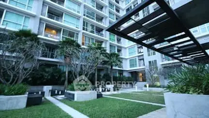 Modern apartment building with lush garden and sleek architecture