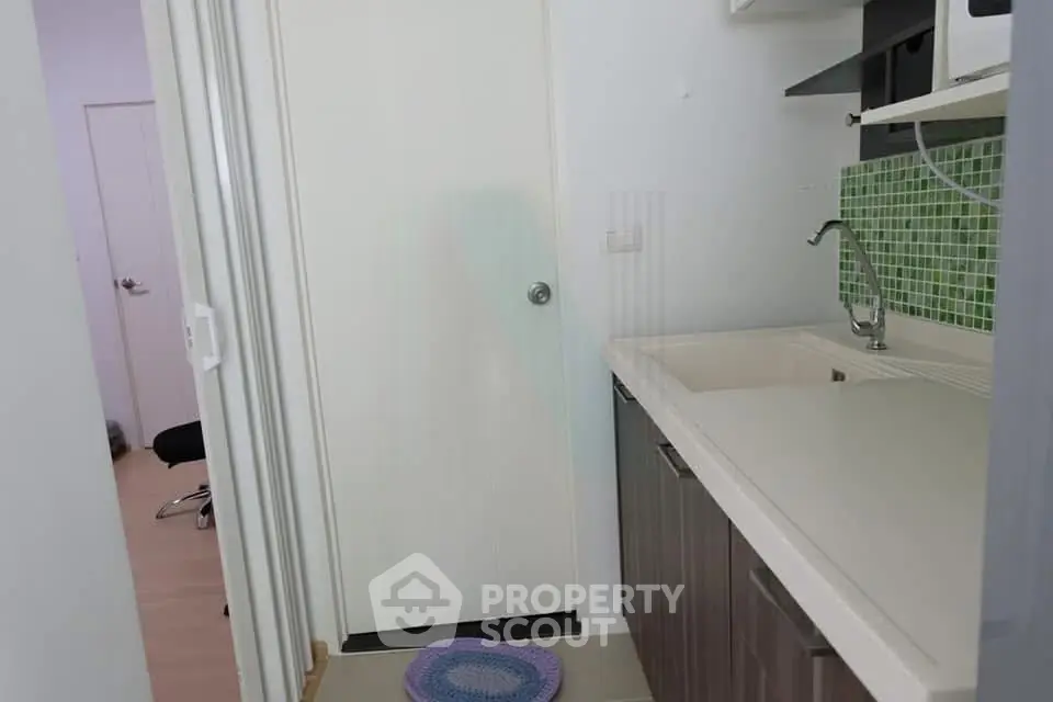 Compact kitchen with modern cabinetry and green tile backsplash
