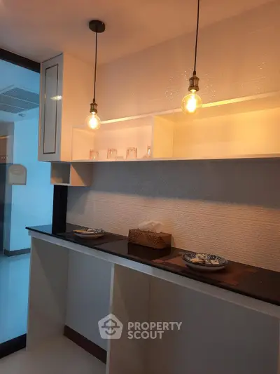 Modern kitchen with stylish lighting and open shelving