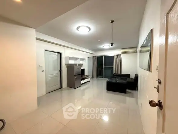 Spacious modern living room with sleek tile flooring and stylish furniture, perfect for relaxation and entertainment.