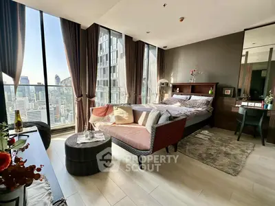 Luxurious bedroom with stunning city view and modern decor in high-rise apartment.