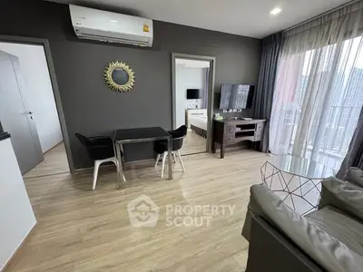 Modern living room with stylish decor and balcony view in a contemporary apartment.
