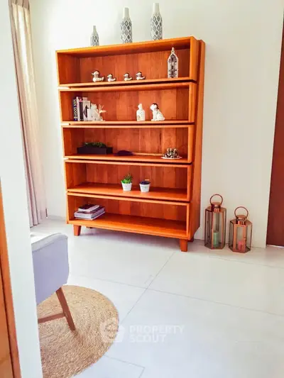 Stylish living room with elegant wooden bookshelf and modern decor accents.
