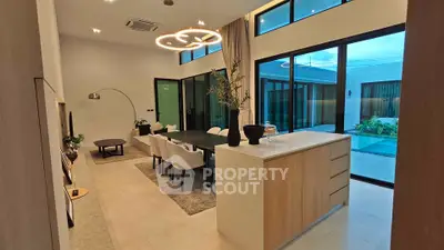 Luxurious open-plan living room with pool view and modern lighting