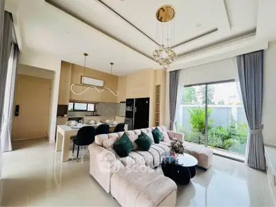 Luxurious open-plan living room with modern kitchen and garden view, featuring elegant decor and ample natural light.