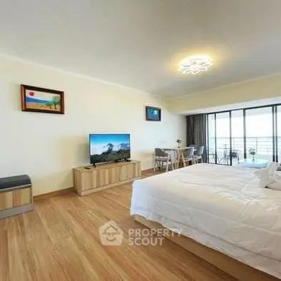 Spacious bedroom with modern decor and balcony view