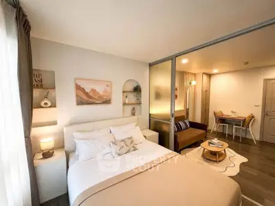 Modern studio apartment with cozy bedroom and stylish living area, featuring elegant decor and warm lighting.