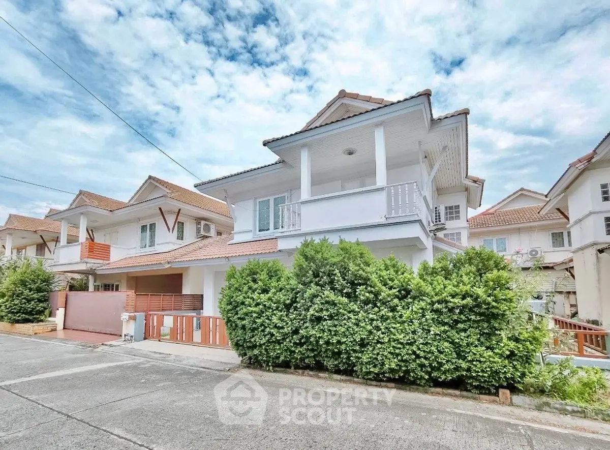 Charming suburban house with lush greenery and modern design in a peaceful neighborhood.