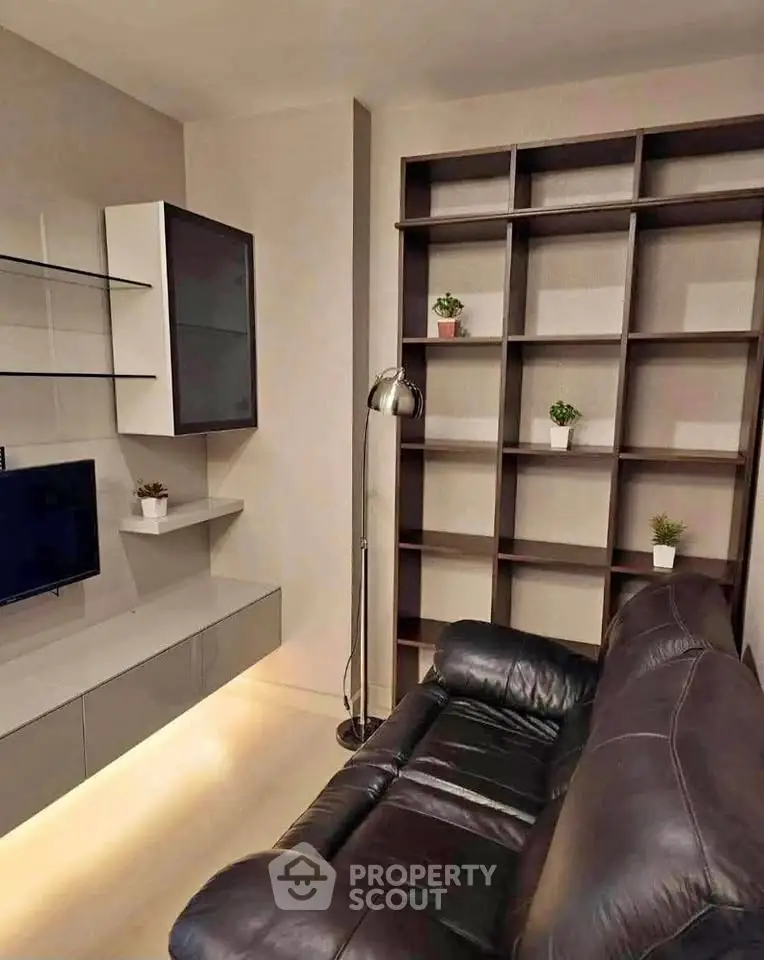 Modern living room with sleek shelving and leather sofa, perfect for stylish urban living.