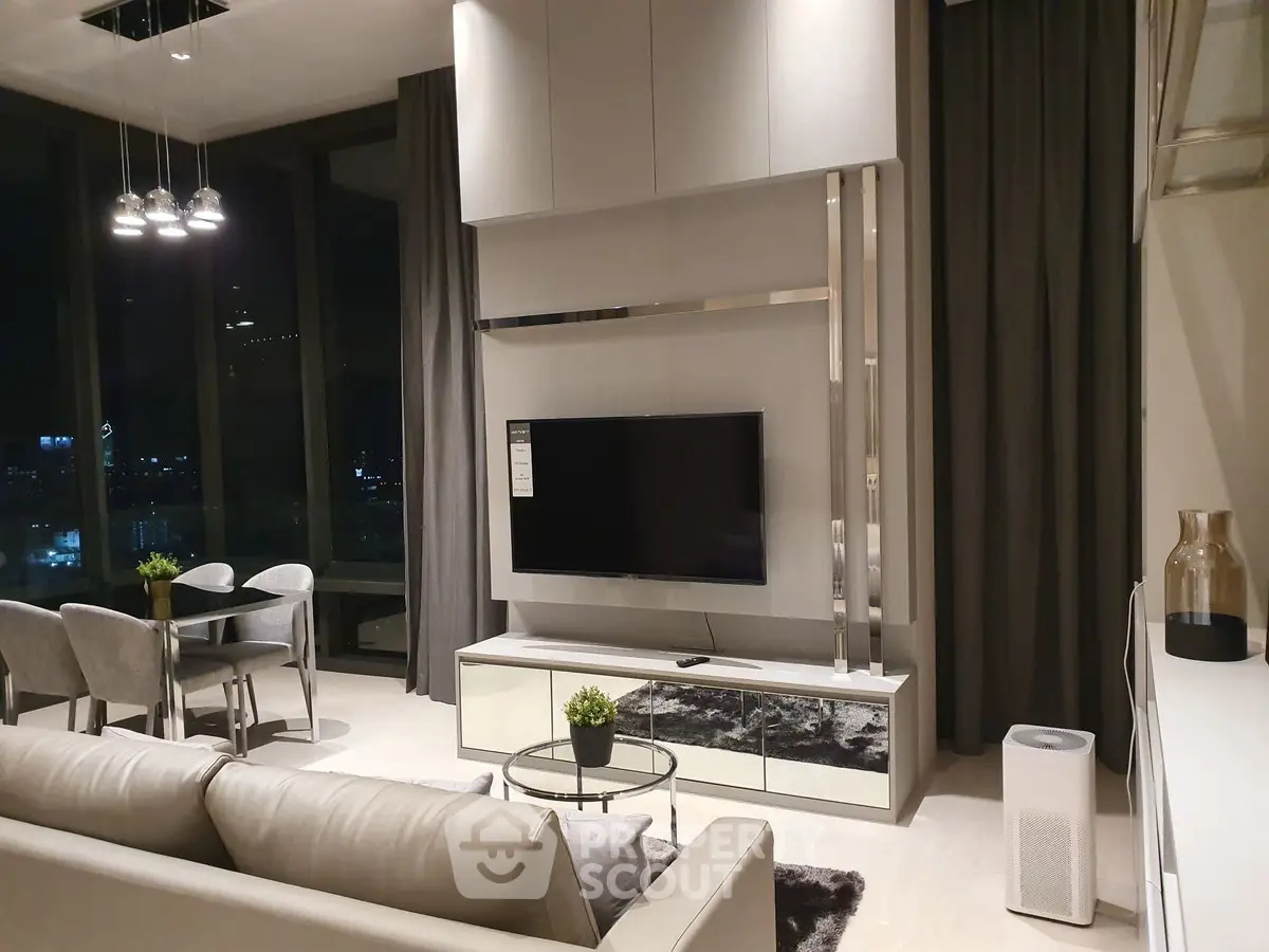Luxurious modern living room with elegant decor and city view at night.