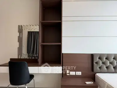 Modern bedroom with stylish furniture and elegant decor, featuring a tufted headboard and sleek vanity area.