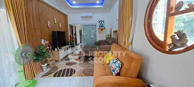 Spacious living room with modern decor and cozy seating area