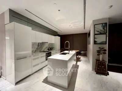 Modern kitchen with sleek white cabinetry and marble accents