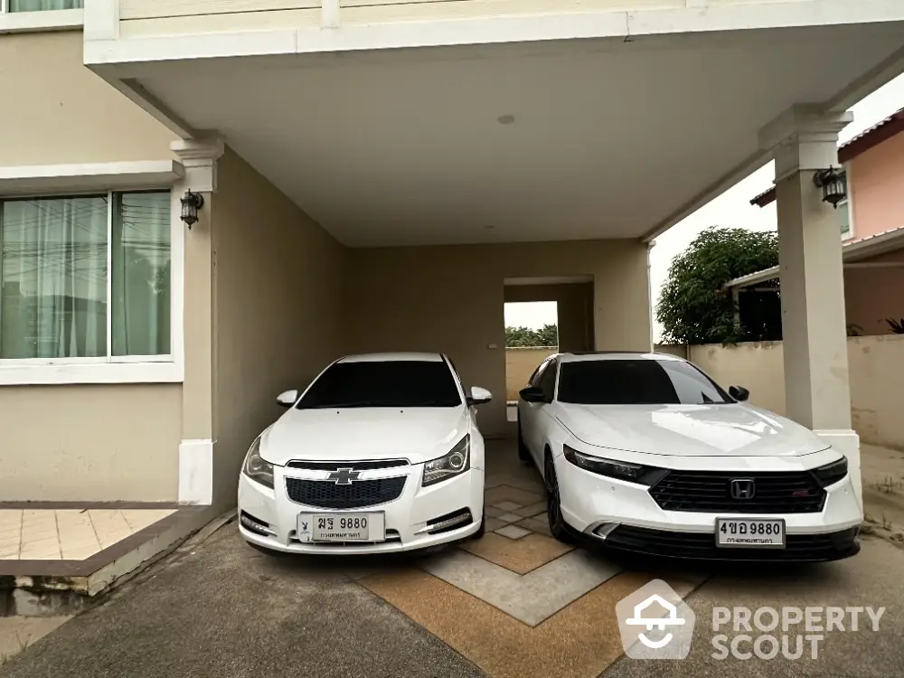 Covered parking space with two cars in a modern residential property