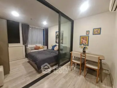 Modern studio apartment with glass partition and cozy dining area