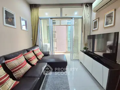 Modern living room with sleek furniture and balcony access in a stylish apartment.