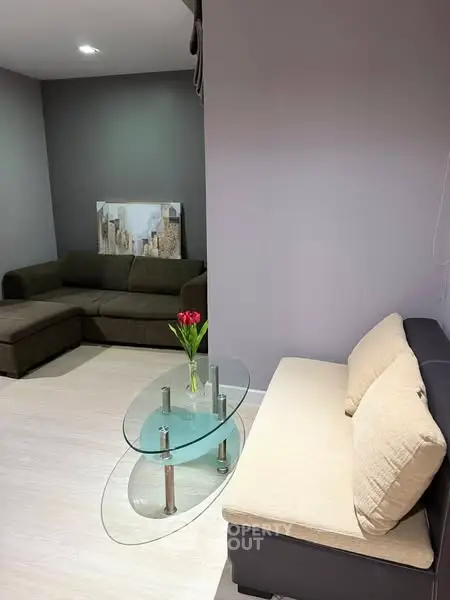 Modern living room with stylish furniture and glass coffee table